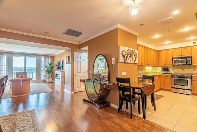 100 Harbor View Dr Unit 607, Port Washington, NY 11050 - dining room with light wood-type flooring and crown molding