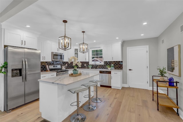 2614 Milburn Ave, Baldwin, NY 11510 - kitchen with stainless steel appliances, white cabinetry, backsplash, light wood-style floors, and recessed lighting