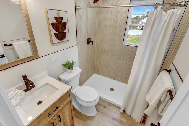 2614 Milburn Ave, Baldwin, NY 11510 - bathroom with toilet, a tile shower, vanity, and wood finished floors