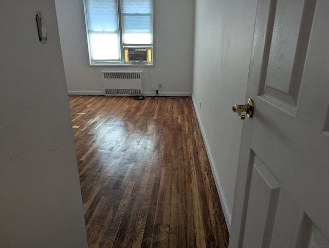 325 King St Unit 6J, Port Chester, NY 10573 - spare room featuring radiator, dark wood finished floors, and cooling unit