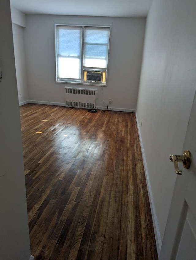 325 King St Unit 6J, Port Chester, NY 10573 - spare room featuring radiator, dark wood-style floors, and cooling unit