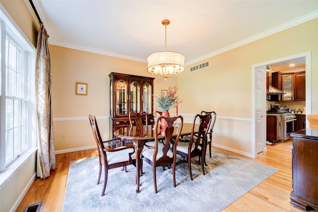 2 Marion Way, Lagrangeville, NY 12540 - dining space featuring a chandelier, plenty of natural light, light wood-style flooring, and ornamental molding