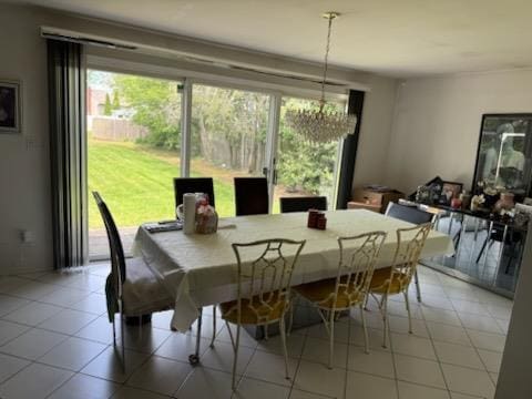 1055 Melissa Ln, North Bellmore, NY 11710 - dining room with a chandelier and healthy amount of natural light