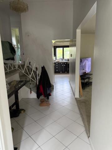 1055 Melissa Ln, North Bellmore, NY 11710 - hallway with light tile patterned floors