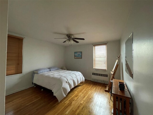 1430 Thieriot Ave Unit 6J, Bronx, NY 10460 - bedroom featuring radiator, wood finished floors, baseboards, and ceiling fan