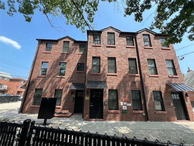56-75 136th St Unit 2A, Flushing, NY 11354 - view of property with a fenced front yard and brick siding