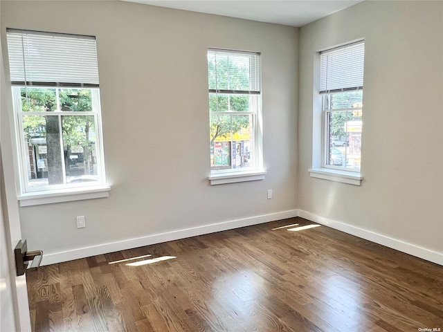 56-75 136th St Unit 2A, Flushing, NY 11354 - spare room with dark wood-type flooring and baseboards