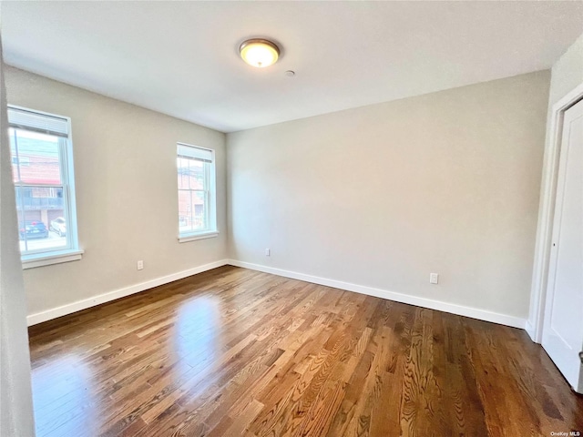 56-75 136th St Unit 2A, Flushing, NY 11354 - unfurnished room featuring wood finished floors and baseboards