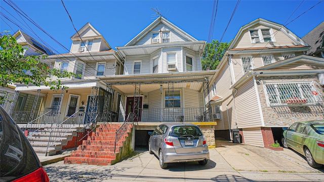 5214 92nd St, Elmhurst, NY 11373 - townhome / multi-family property with a porch and stairway