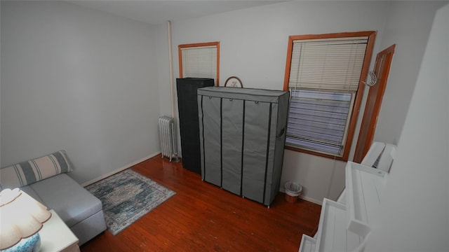 5214 92nd St, Elmhurst, NY 11373 - sitting room with radiator, wood finished floors, and baseboards