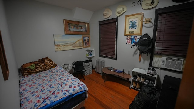 5214 92nd St, Elmhurst, NY 11373 - bedroom featuring radiator heating unit, wood finished floors, and cooling unit