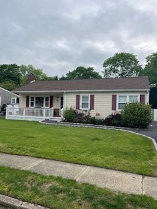 24 Gen Mclean Dr, Bellport Village, NY 11713 - ranch-style home featuring covered porch, a chimney, and a front yard
