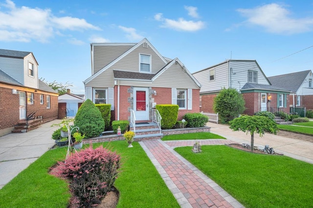 56 Mary St, Valley Stream, NY 11580 - view of front facade with brick siding and a front yard