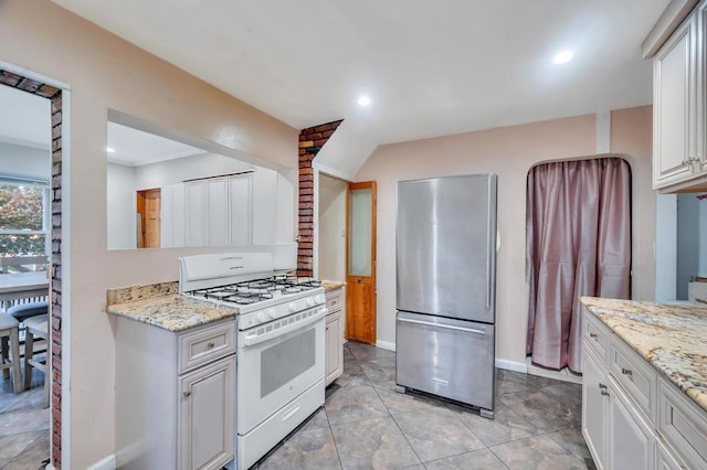 56 Mary St, Valley Stream, NY 11580 - kitchen featuring white range with gas cooktop, freestanding refrigerator, light stone countertops, recessed lighting, and baseboards