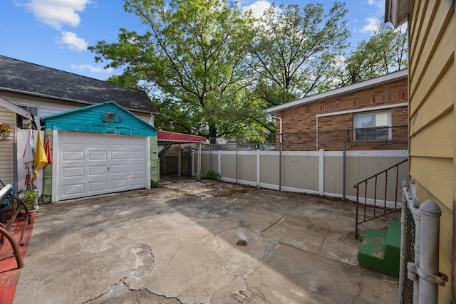 12104 Linden Blvd, South Ozone Park, NY 11420 - view of patio featuring concrete driveway and an outbuilding
