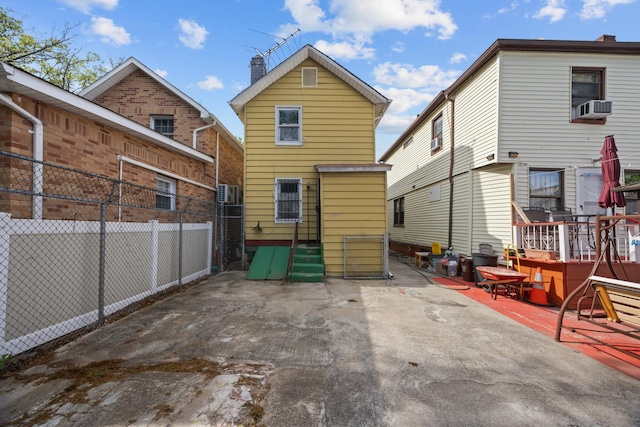 12104 Linden Blvd, South Ozone Park, NY 11420 - rear view of house featuring cooling unit, a chimney, and a patio