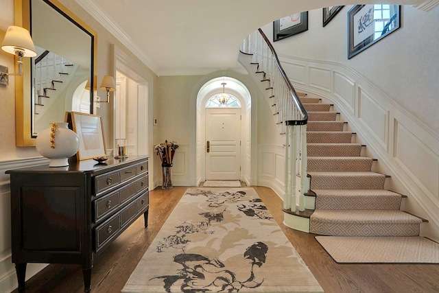 191 Elderfields Rd, Manhasset, NY 11030 - entrance foyer with stairs, a decorative wall, wood finished floors, crown molding, and a wainscoted wall
