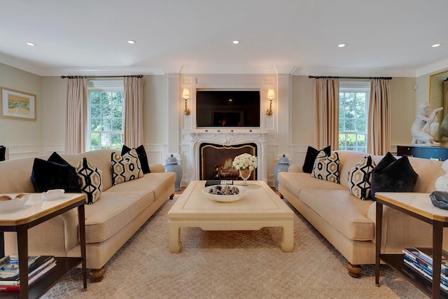 191 Elderfields Rd, Manhasset, NY 11030 - living room featuring crown molding, healthy amount of natural light, a premium fireplace, a wainscoted wall, and a decorative wall