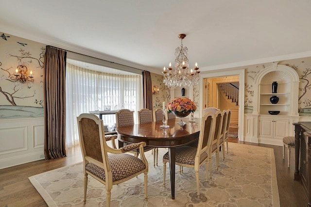 191 Elderfields Rd, Manhasset, NY 11030 - dining space with a chandelier, ornamental molding, wood finished floors, wainscoting, and a decorative wall
