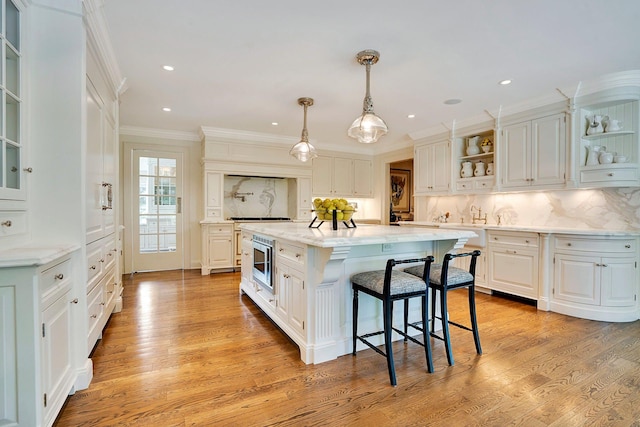 191 Elderfields Rd, Manhasset, NY 11030 - kitchen featuring open shelves, stainless steel microwave, a center island, white cabinets, and crown molding