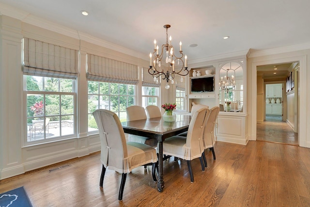 191 Elderfields Rd, Manhasset, NY 11030 - dining room with a chandelier, wood finished floors, crown molding, and a decorative wall