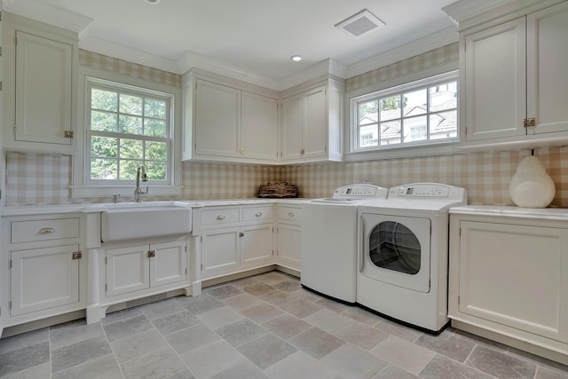 191 Elderfields Rd, Manhasset, NY 11030 - washroom with cabinet space, washer and dryer, plenty of natural light, light stone finish flooring, and ornamental molding