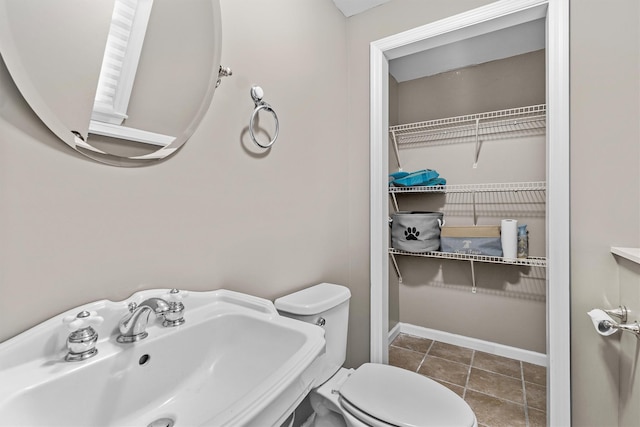 491 Toleman Rd, Rock Tavern, NY 12575 - bathroom with a sink, toilet, a spacious closet, and tile patterned flooring