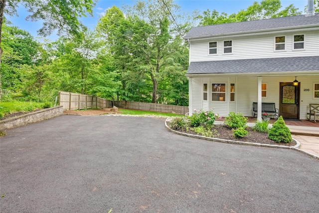 100 Castle Rd, Chappaqua, NY 10514 - view of front of house featuring roof with shingles and a porch