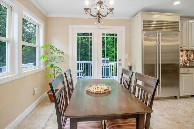 100 Castle Rd, Chappaqua, NY 10514 - dining area with a chandelier, baseboards, healthy amount of natural light, crown molding, and light tile patterned floors