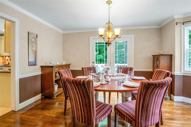 100 Castle Rd, Chappaqua, NY 10514 - dining area with healthy amount of natural light, light wood-type flooring, a chandelier, crown molding, and baseboards