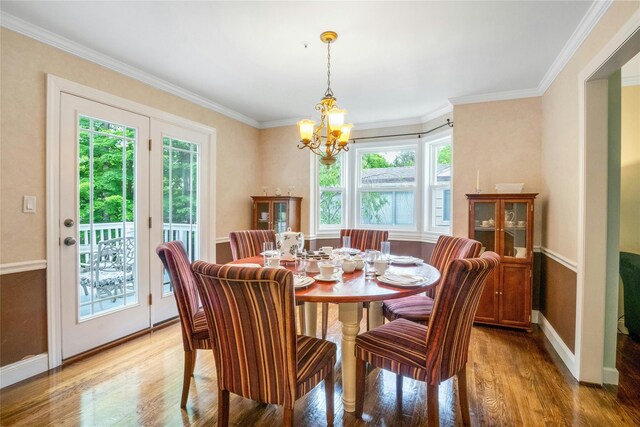 100 Castle Rd, Chappaqua, NY 10514 - dining space featuring healthy amount of natural light, light wood-style floors, a chandelier, baseboards, and ornamental molding