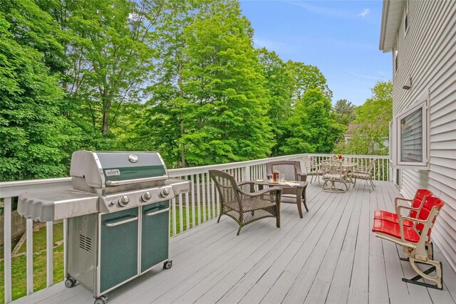 100 Castle Rd, Chappaqua, NY 10514 - wooden deck featuring outdoor dining area, a grill, and view of scattered trees