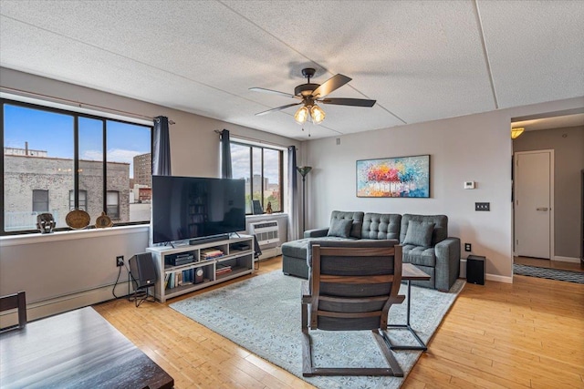 342 E 119th St Unit 6D, New York Manhattan, NY 10035 - living area with ceiling fan, a textured ceiling, and wood finished floors