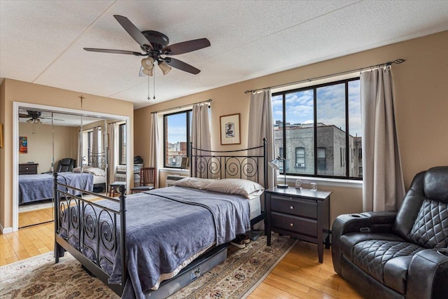 342 E 119th St Unit 6D, New York Manhattan, NY 10035 - bedroom with wood-type flooring, multiple windows, a textured ceiling, and ceiling fan