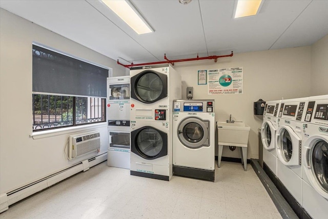 342 E 119th St Unit 6D, New York Manhattan, NY 10035 - community laundry room with estacked washer and dryer, separate washer and dryer, a baseboard radiator, light floors, and a wall mounted AC