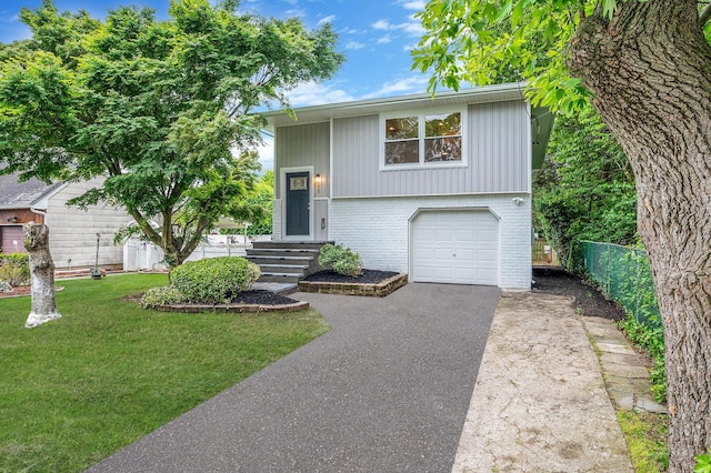 116 Amsterdam Ave, West Babylon, NY 11704 - bi-level home featuring brick siding, asphalt driveway, and an attached garage
