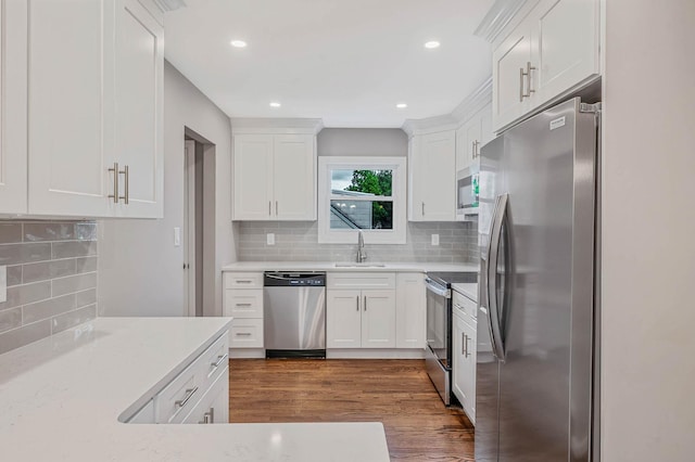 116 Amsterdam Ave, West Babylon, NY 11704 - kitchen with appliances with stainless steel finishes, a sink, decorative backsplash, dark wood-style floors, and white cabinets