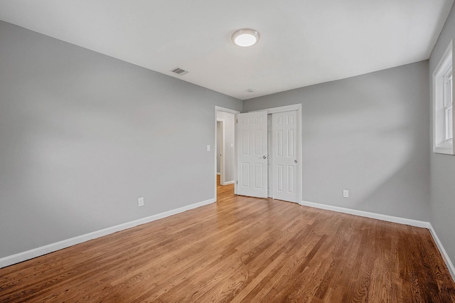 116 Amsterdam Ave, West Babylon, NY 11704 - unfurnished bedroom with baseboards, light wood-type flooring, and a closet