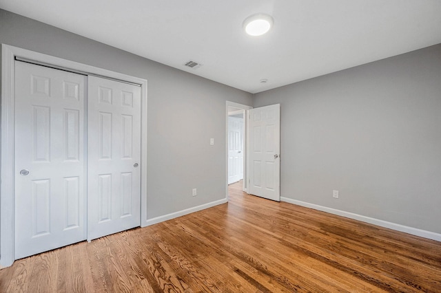 116 Amsterdam Ave, West Babylon, NY 11704 - unfurnished bedroom with baseboards, wood finished floors, and a closet
