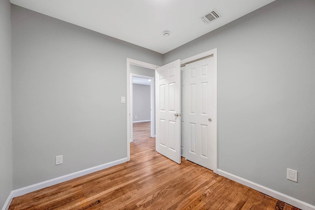 116 Amsterdam Ave, West Babylon, NY 11704 - unfurnished bedroom with baseboards, light wood-style floors, and a closet