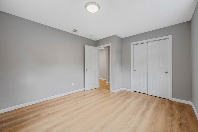 116 Amsterdam Ave, West Babylon, NY 11704 - unfurnished bedroom featuring wood finished floors, baseboards, and a closet