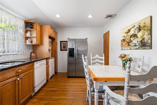 224 Washington Ave, Saint James, NY 11780 - kitchen with stainless steel fridge with ice dispenser, white dishwasher, open shelves, wood finished floors, and a sink