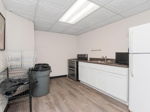101 Highland Ave Unit 3P, Yonkers, NY 10705 - kitchen with double oven range, freestanding refrigerator, white cabinetry, light wood-style flooring, and an ornate ceiling