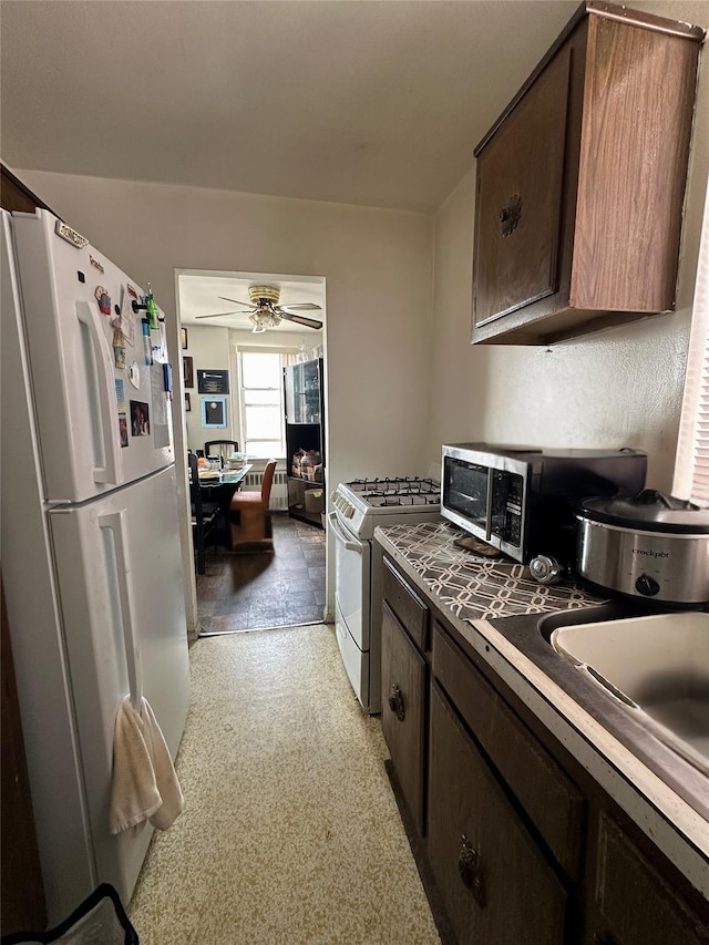 101 Highland Ave Unit 3P, Yonkers, NY 10705 - kitchen featuring white appliances, dark brown cabinetry, and ceiling fan