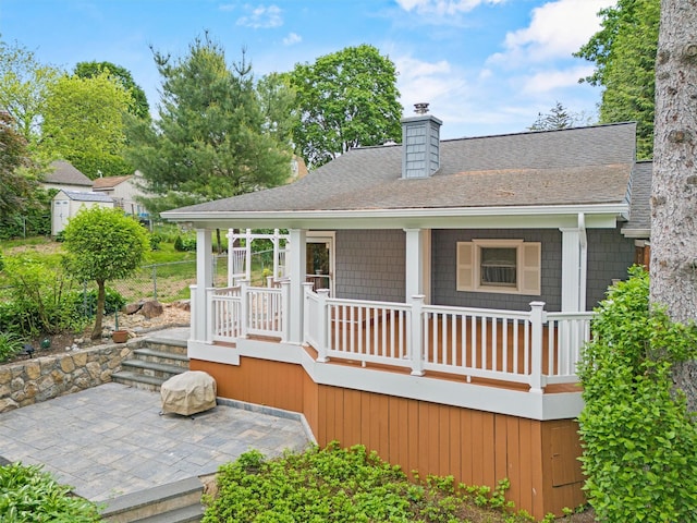 12 Hillside Ter, Amawalk, NY 10501 - rear view of property with roof with shingles, a chimney, covered porch, and a patio