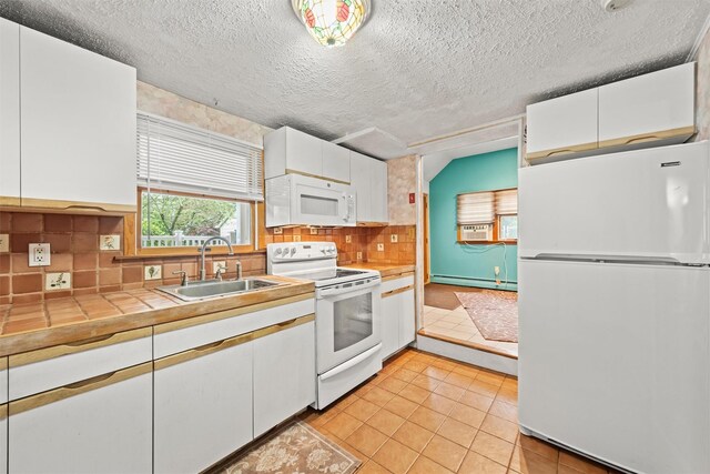 12 Hillside Ter, Amawalk, NY 10501 - kitchen with white appliances, baseboard heating, a sink, white cabinetry, and a textured ceiling