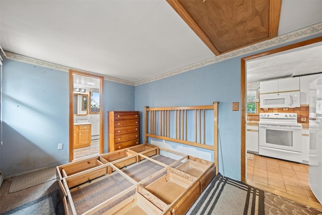 12 Hillside Ter, Amawalk, NY 10501 - bedroom with a baseboard heating unit, light tile patterned floors, and connected bathroom