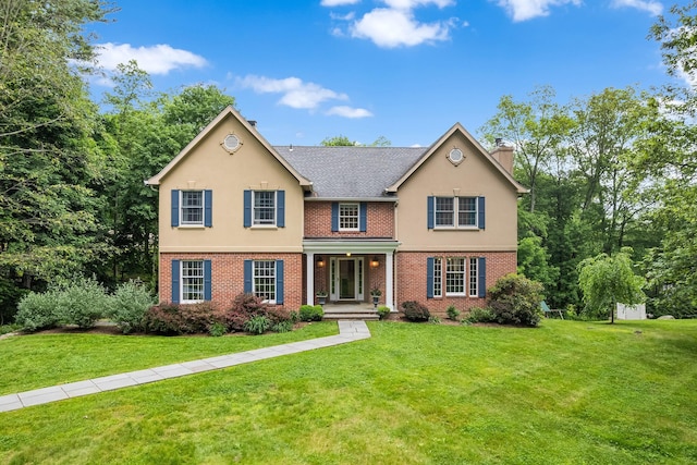 8 Upland Ct, South Salem, NY 10590 - view of front facade featuring a chimney, a porch, brick siding, and a front lawn
