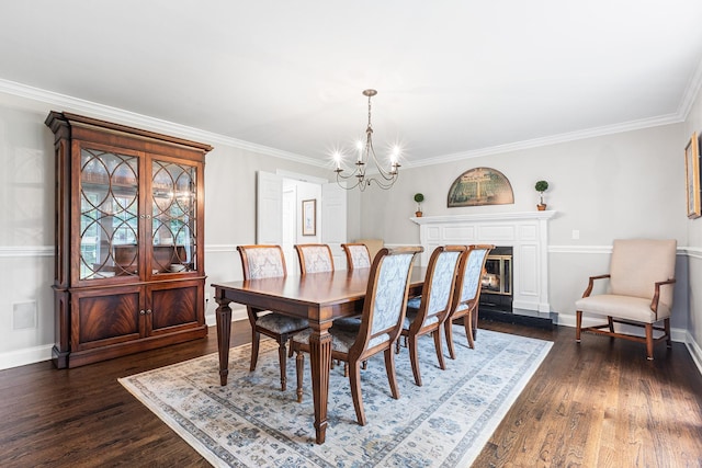 8 Upland Ct, South Salem, NY 10590 - dining space featuring a chandelier, dark wood-style floors, baseboards, crown molding, and a glass covered fireplace
