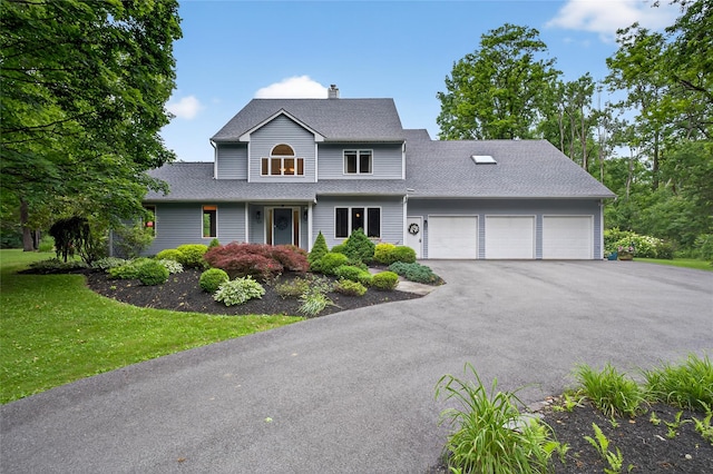 109 Sleight Plass Rd, Poughkeepsie, NY 12603 - traditional home featuring an attached garage, asphalt driveway, a chimney, a front yard, and roof with shingles